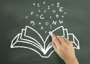 words flying out from book drawn by hand over chalkboard