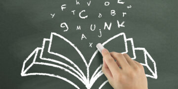 words flying out from book drawn by hand over chalkboard